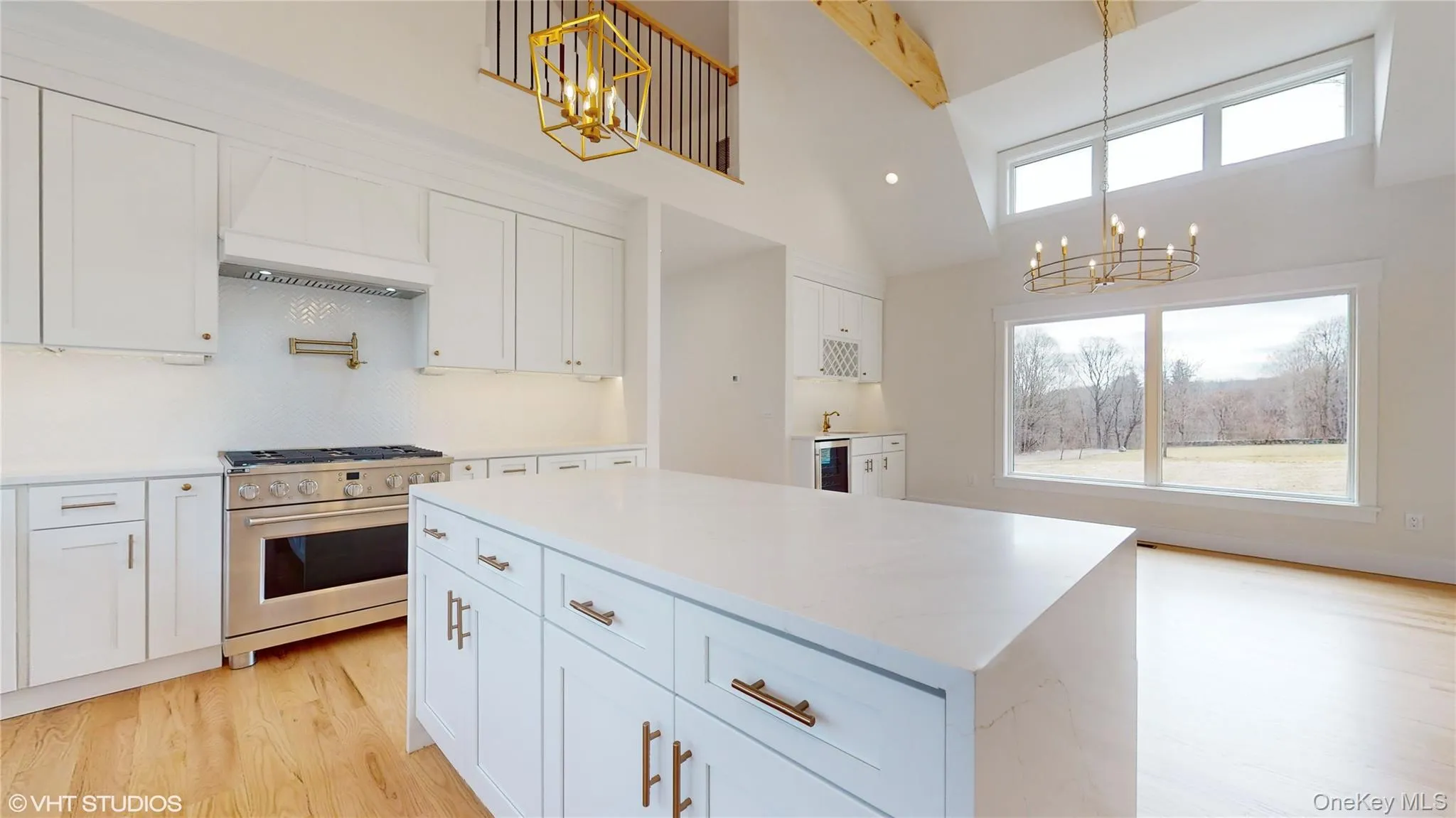 Kitchen featuring premium range hood, white cabinets, and stainless steel stove Kitchen featuring premium range hood, white cabinets, and stainless steel stove