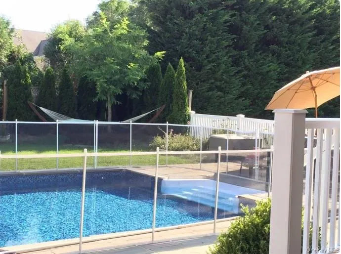 View of pool with a patio and optional child safety fence. View of pool with a patio and optional child safety fence.