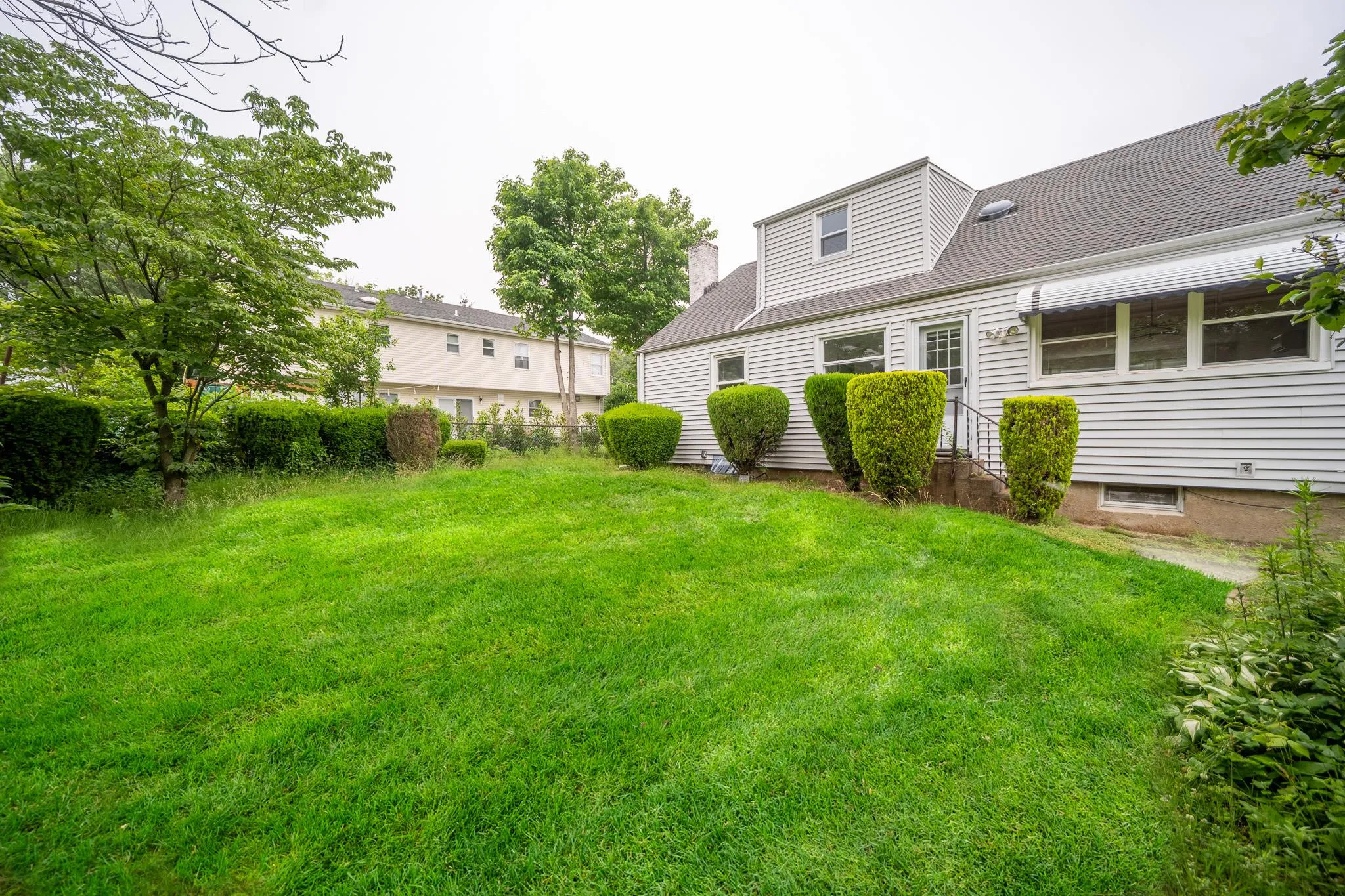 View of green lawn with entry steps View of green lawn with entry steps