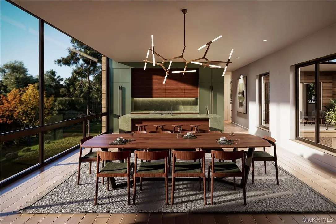 Dining area open to the kitchen, anchored by a fireplace and with amazing walls of windows. Dining area open to the kitchen, anchored by a fireplace and with amazing walls of windows.