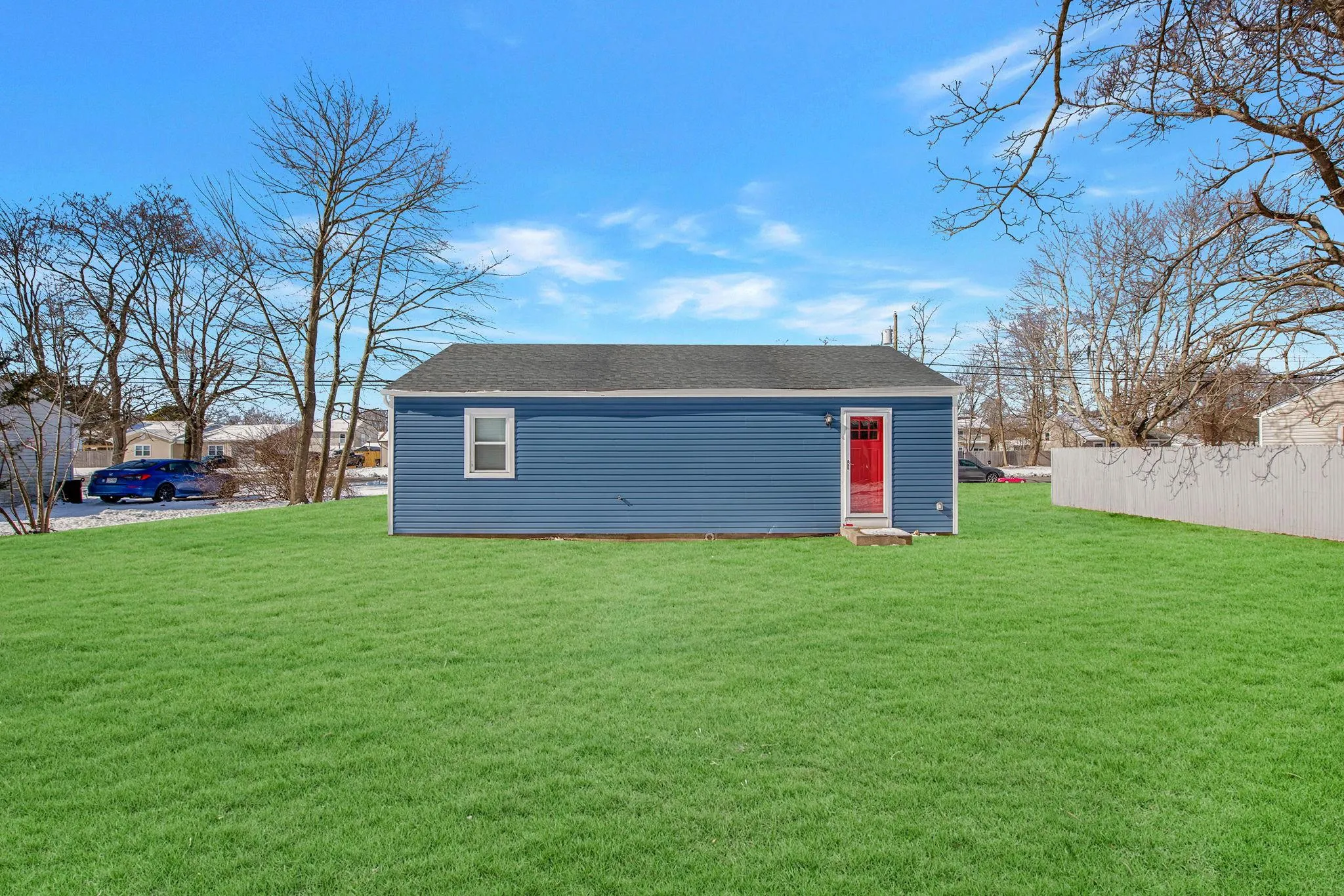 Garage featuring a lawn Garage featuring a lawn