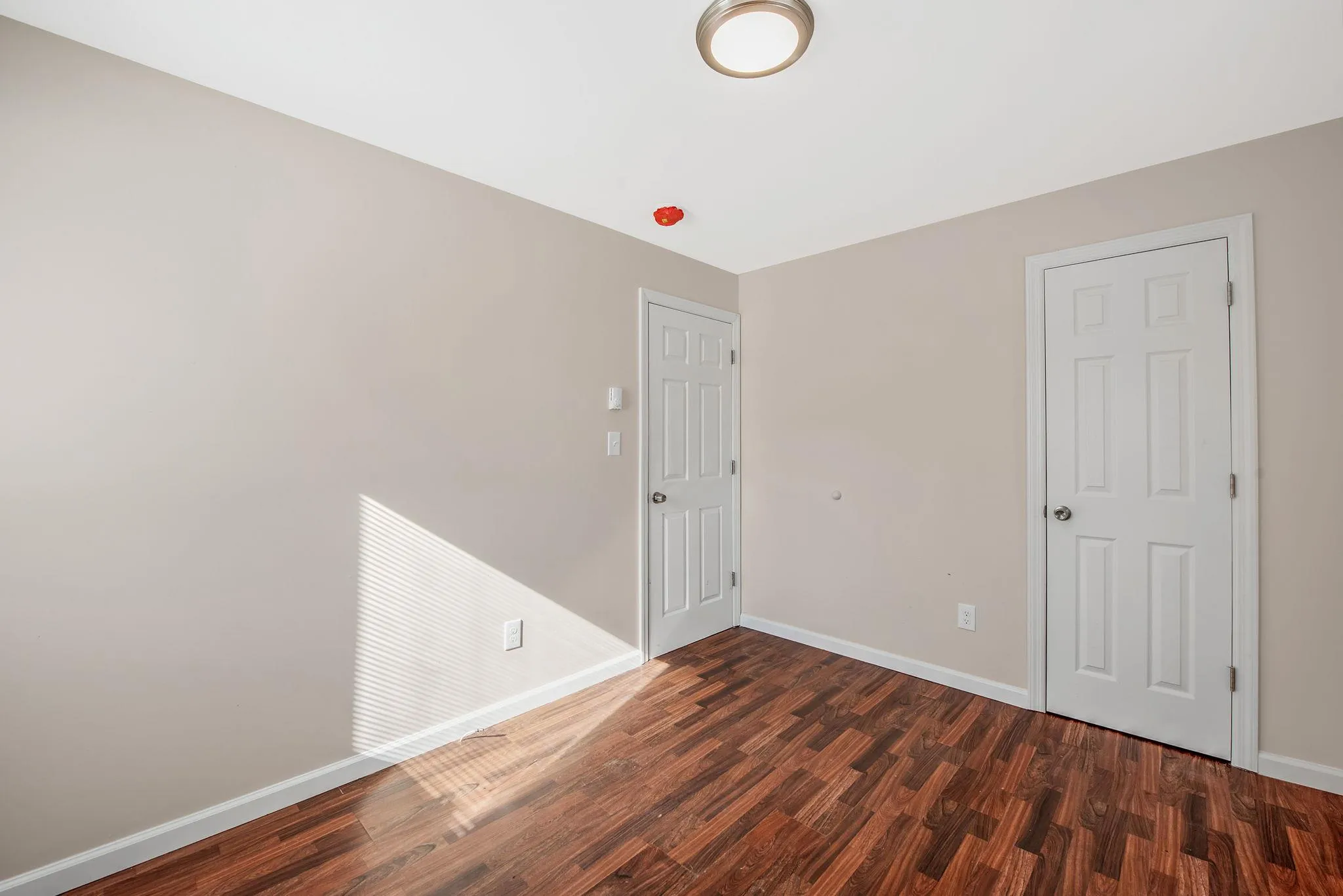 Spare room with dark hardwood / wood-style flooring Spare room with dark hardwood / wood-style flooring