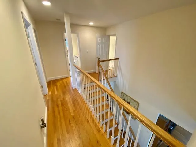 Hallway featuring light hardwood / wood-style floors Hallway featuring light hardwood / wood-style floors