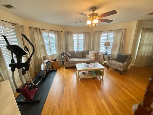 Living room featuring ceiling fan and light hardwood / wood-style floors Living room featuring ceiling fan and light hardwood / wood-style floors