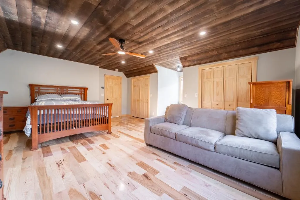 Bedroom with light hardwood / wood-style floors, vaulted ceiling, ceiling fan, and wood ceiling Bedroom with light hardwood / wood-style floors, vaulted ceiling, ceiling fan, and wood ceiling
