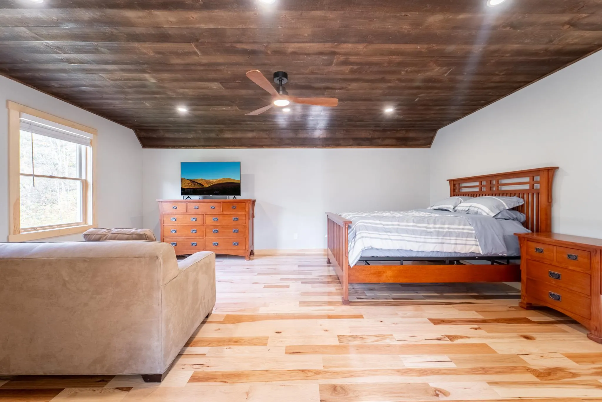 Bedroom featuring ceiling fan, lofted ceiling, wood ceiling, and light hardwood / wood-style flooring Bedroom featuring ceiling fan, lofted ceiling, wood ceiling, and light hardwood / wood-style flooring