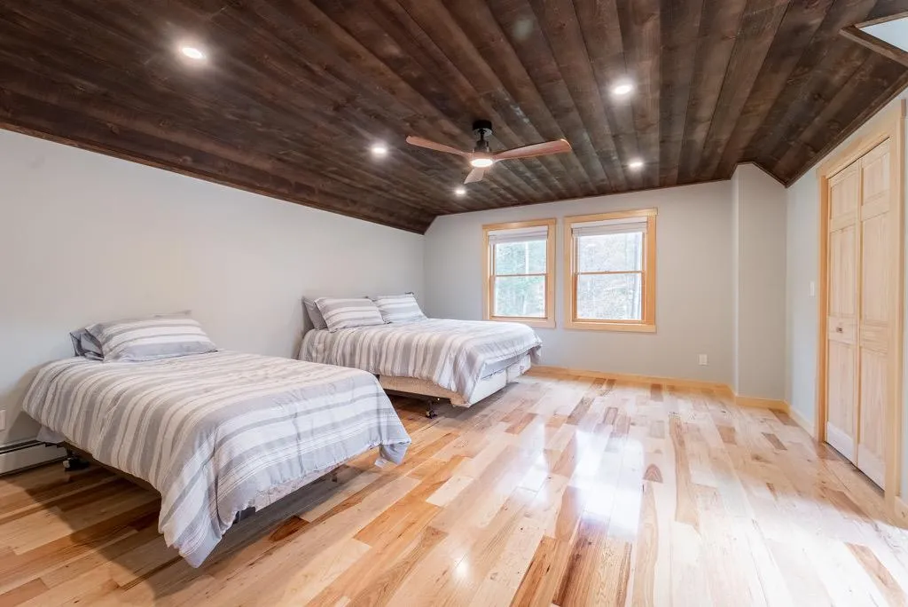 Bedroom with lofted ceiling, light hardwood / wood-style flooring, ceiling fan, and wooden ceiling Bedroom with lofted ceiling, light hardwood / wood-style flooring, ceiling fan, and wooden ceiling
