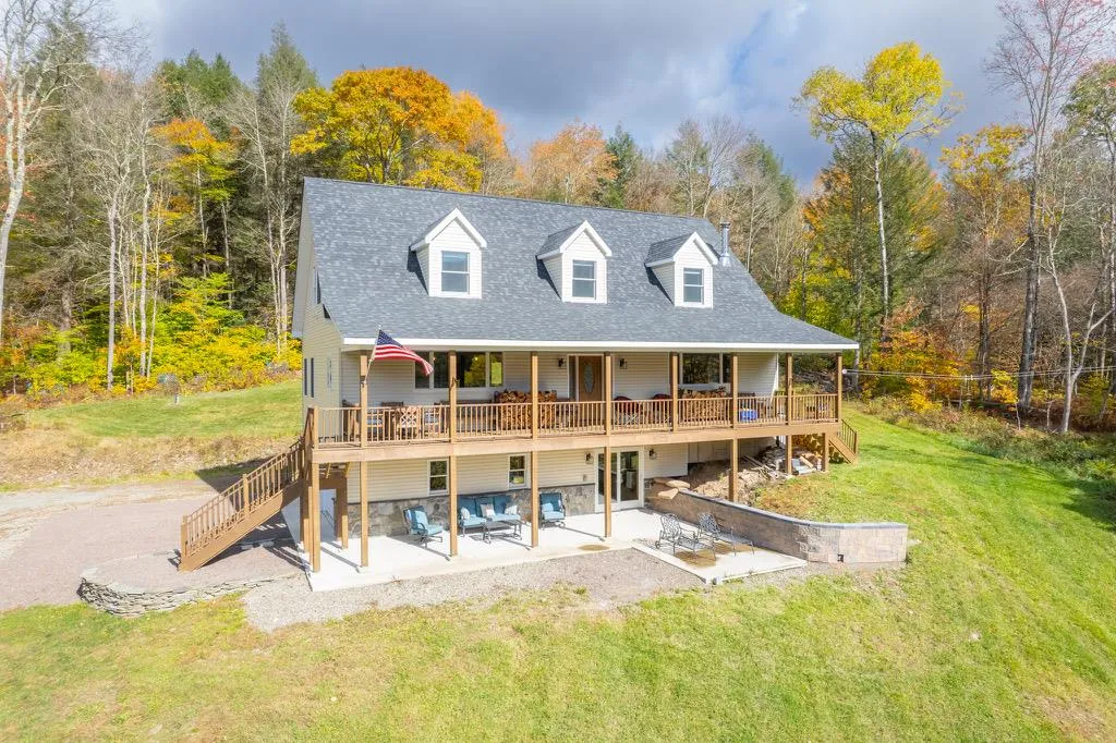 Rear view of property with a wooden deck, a patio area, and a yard Rear view of property with a wooden deck, a patio area, and a yard