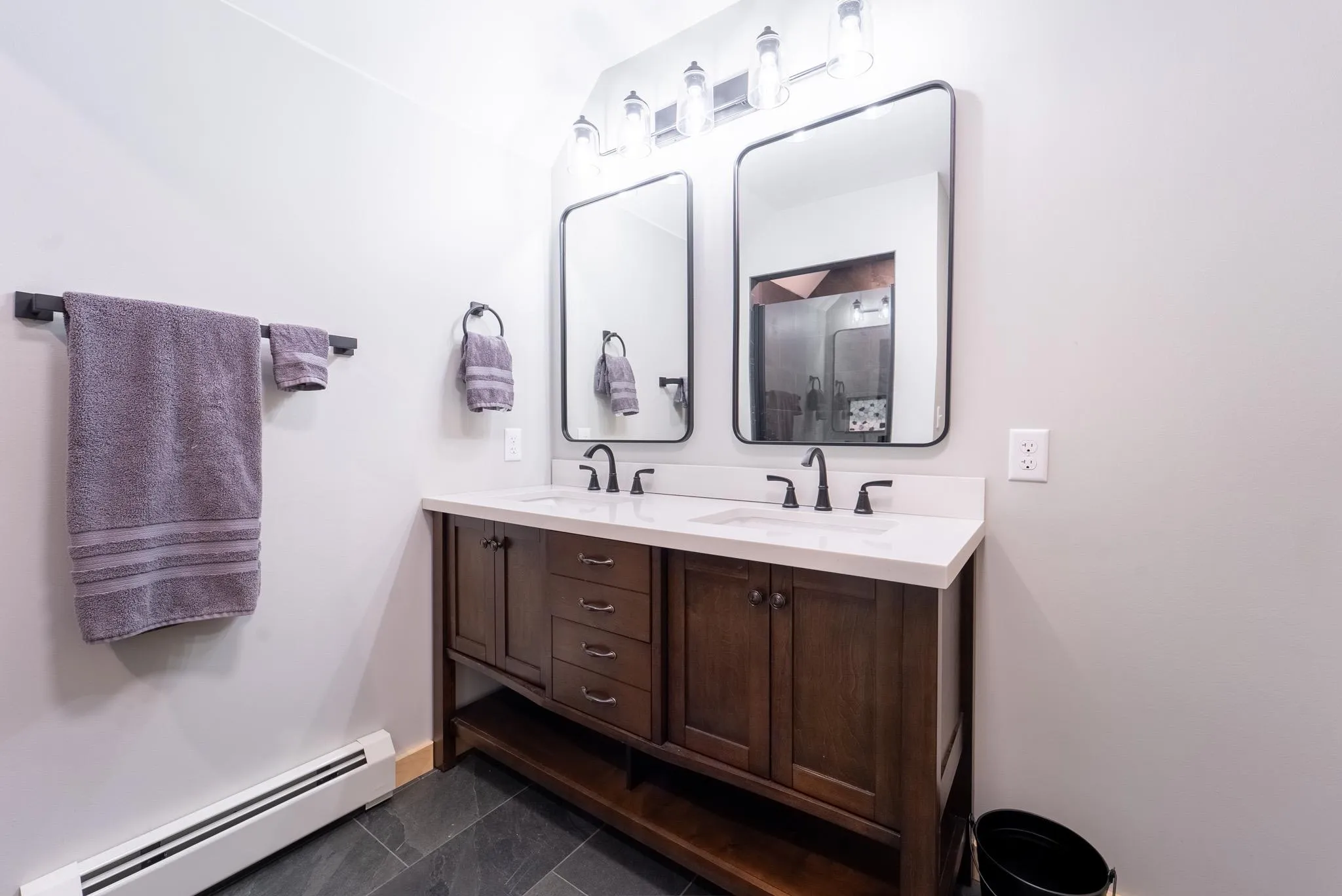 Bathroom featuring vanity, tile patterned floors, and a baseboard heating unit Bathroom featuring vanity, tile patterned floors, and a baseboard heating unit