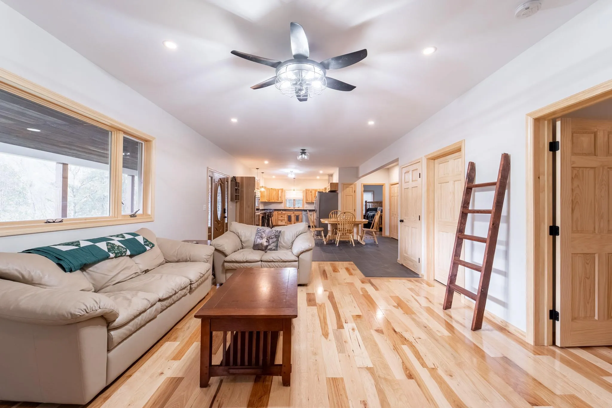 Living room with ceiling fan and light wood-type flooring Living room with ceiling fan and light wood-type flooring