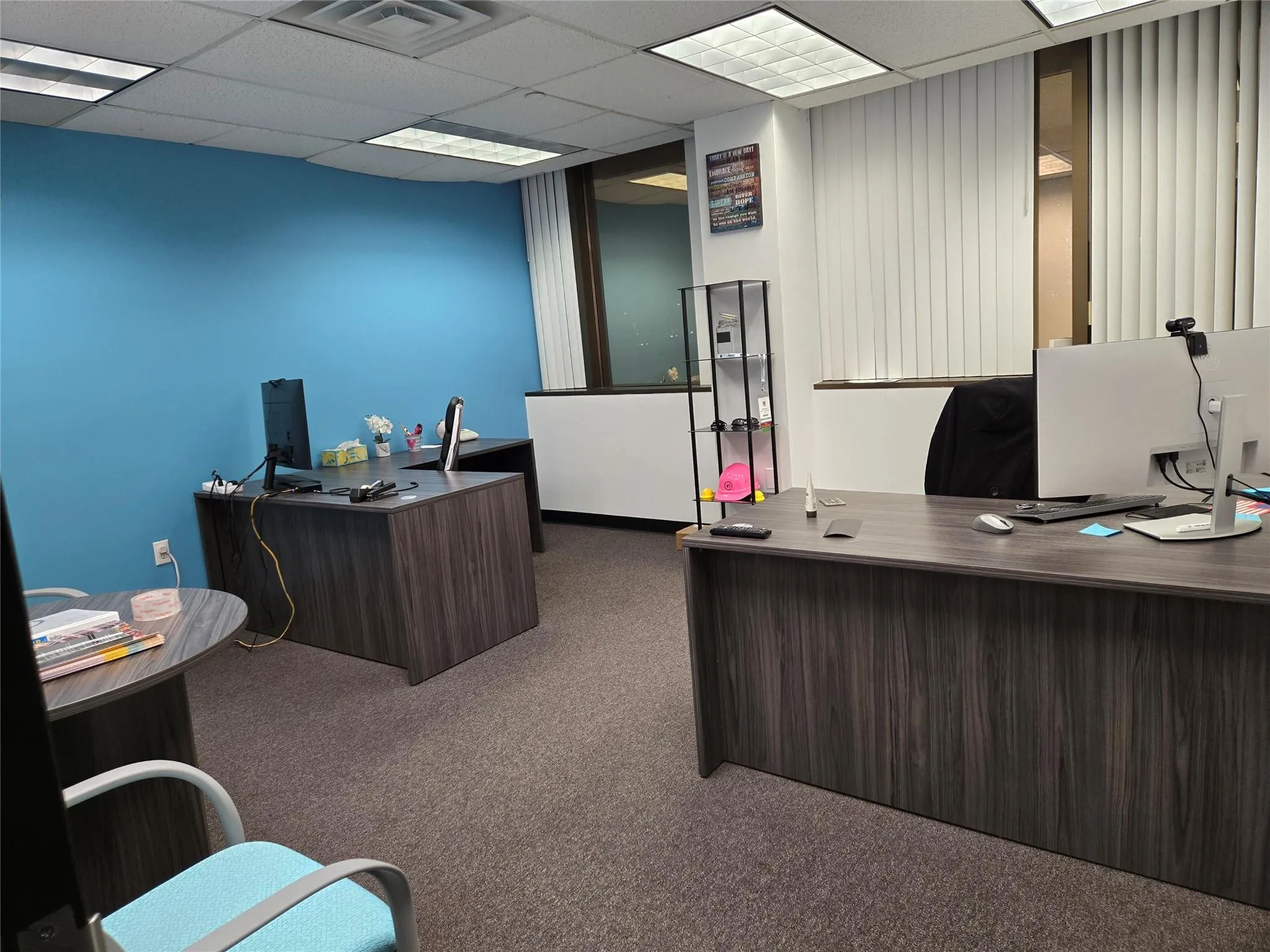 Office space with carpet flooring and a drop ceiling Office space with carpet flooring and a drop ceiling