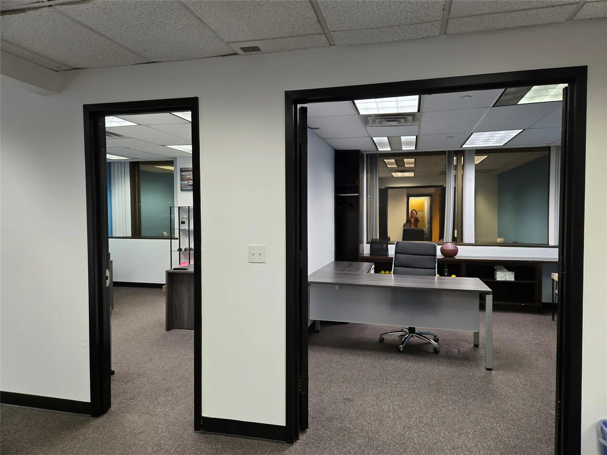 Unfurnished office with a drop ceiling and carpet floors Unfurnished office with a drop ceiling and carpet floors