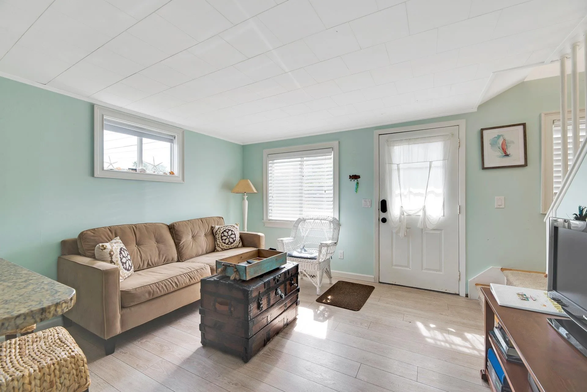 Living room with a healthy amount of sunlight and light wood-type flooring Living room with a healthy amount of sunlight and light wood-type flooring