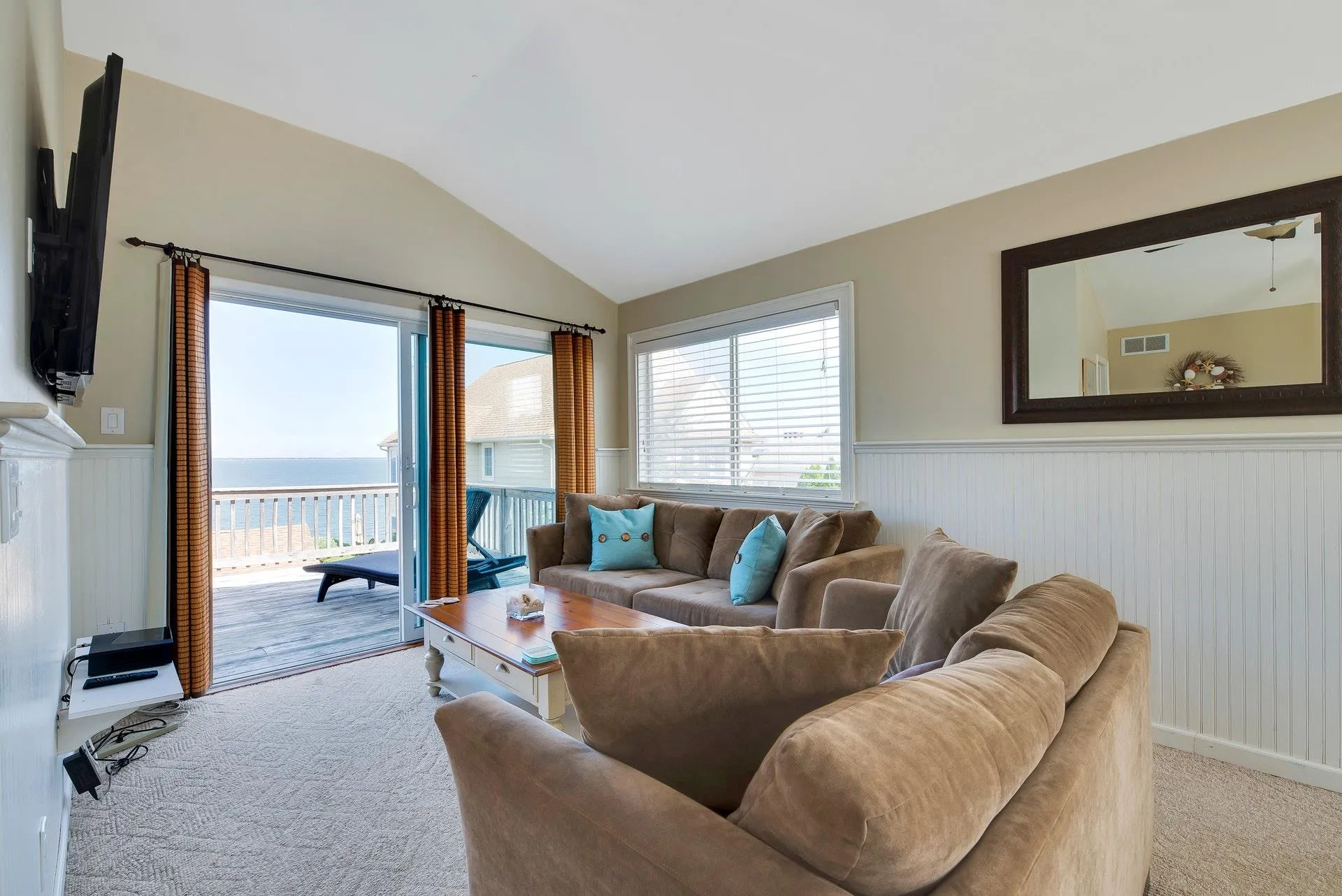 Carpeted living room with ceiling fan and lofted ceiling Carpeted living room with ceiling fan and lofted ceiling
