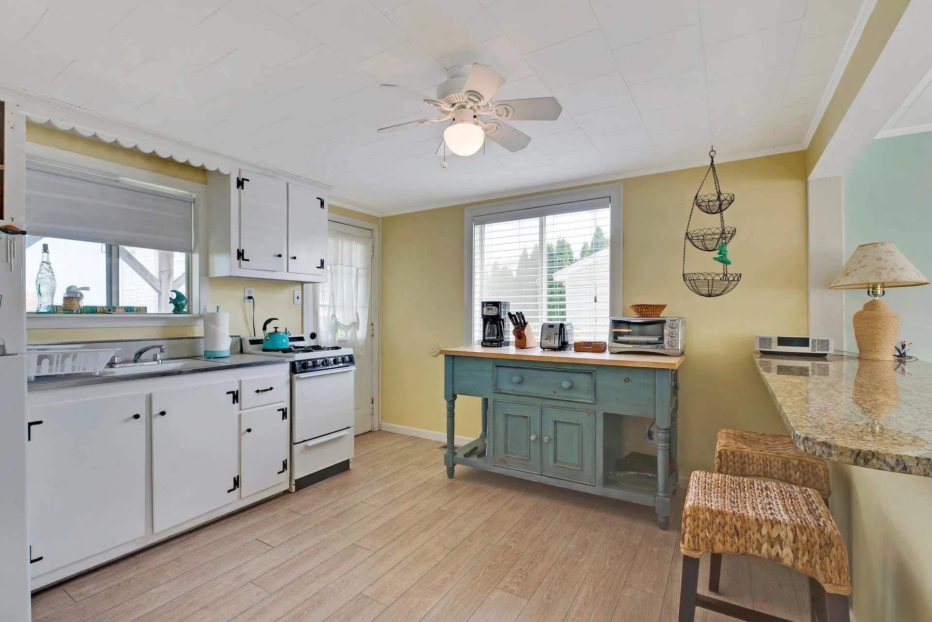 Kitchen with white cabinets, white range oven, green cabinetry, and ornamental molding Kitchen with white cabinets, white range oven, green cabinetry, and ornamental molding