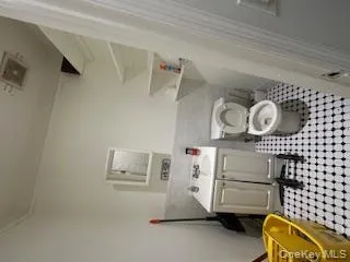 Bathroom with vanity, tile walls, and wainscoting Bathroom with vanity, tile walls, and wainscoting