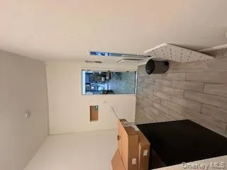 Corridor featuring wood tiled floors and baseboards Corridor featuring wood tiled floors and baseboards