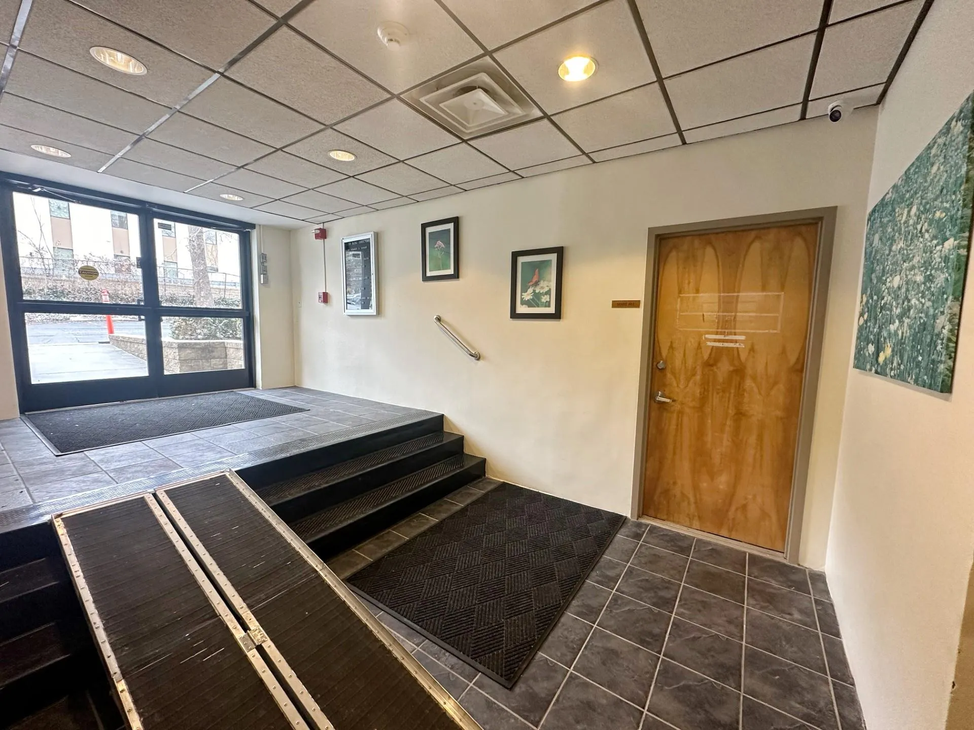 Stairs with tile patterned flooring and a drop ceiling Stairs with tile patterned flooring and a drop ceiling