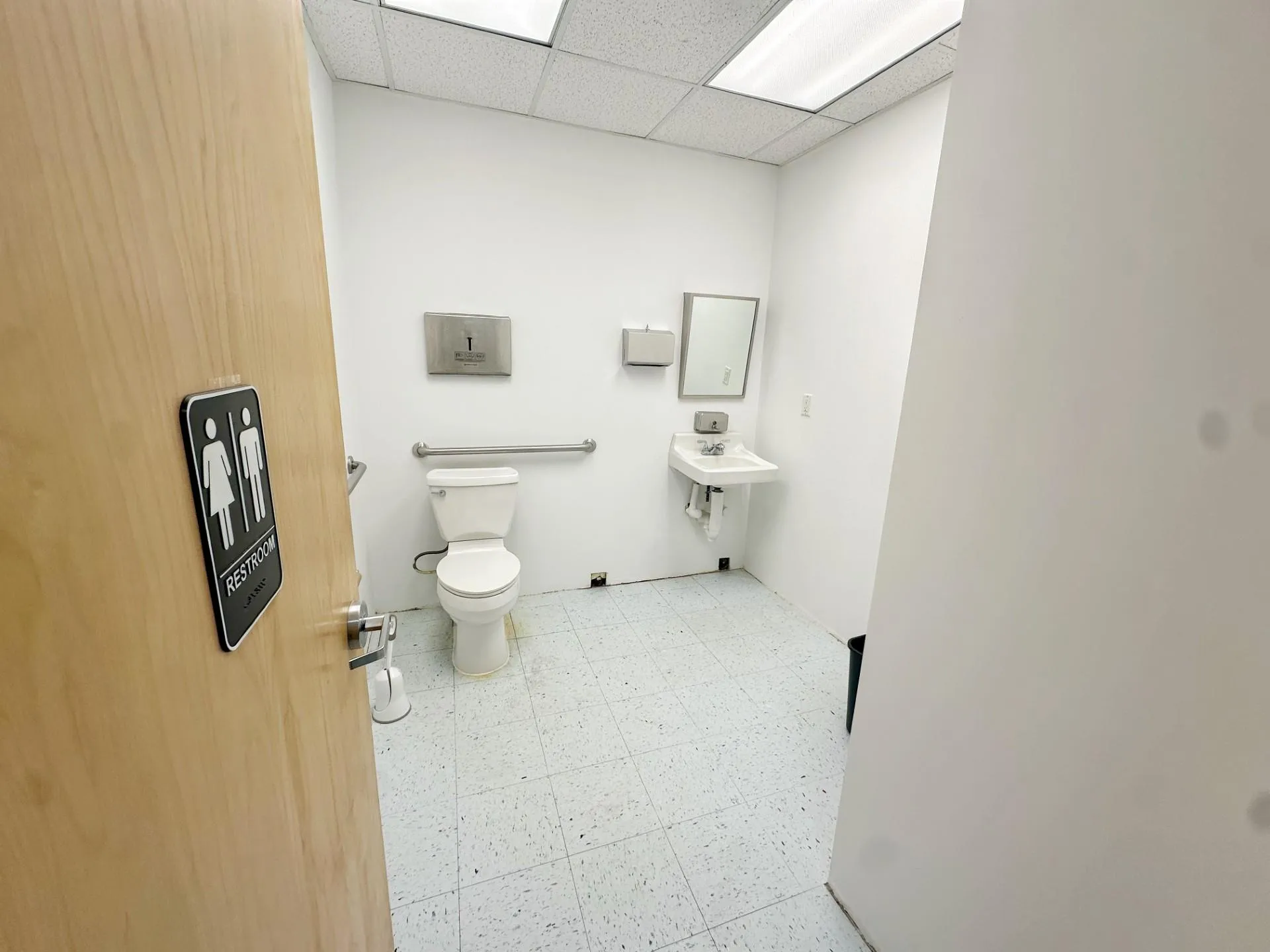 Bathroom with a paneled ceiling, toilet, and sink Bathroom with a paneled ceiling, toilet, and sink