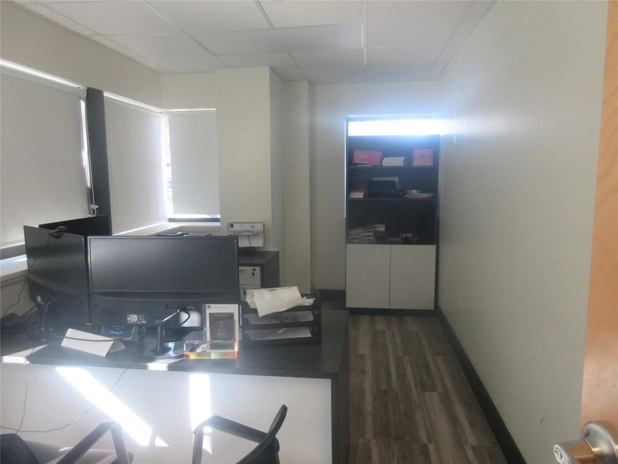 Office space featuring dark hardwood / wood-style floors and a drop ceiling Office space featuring dark hardwood / wood-style floors and a drop ceiling