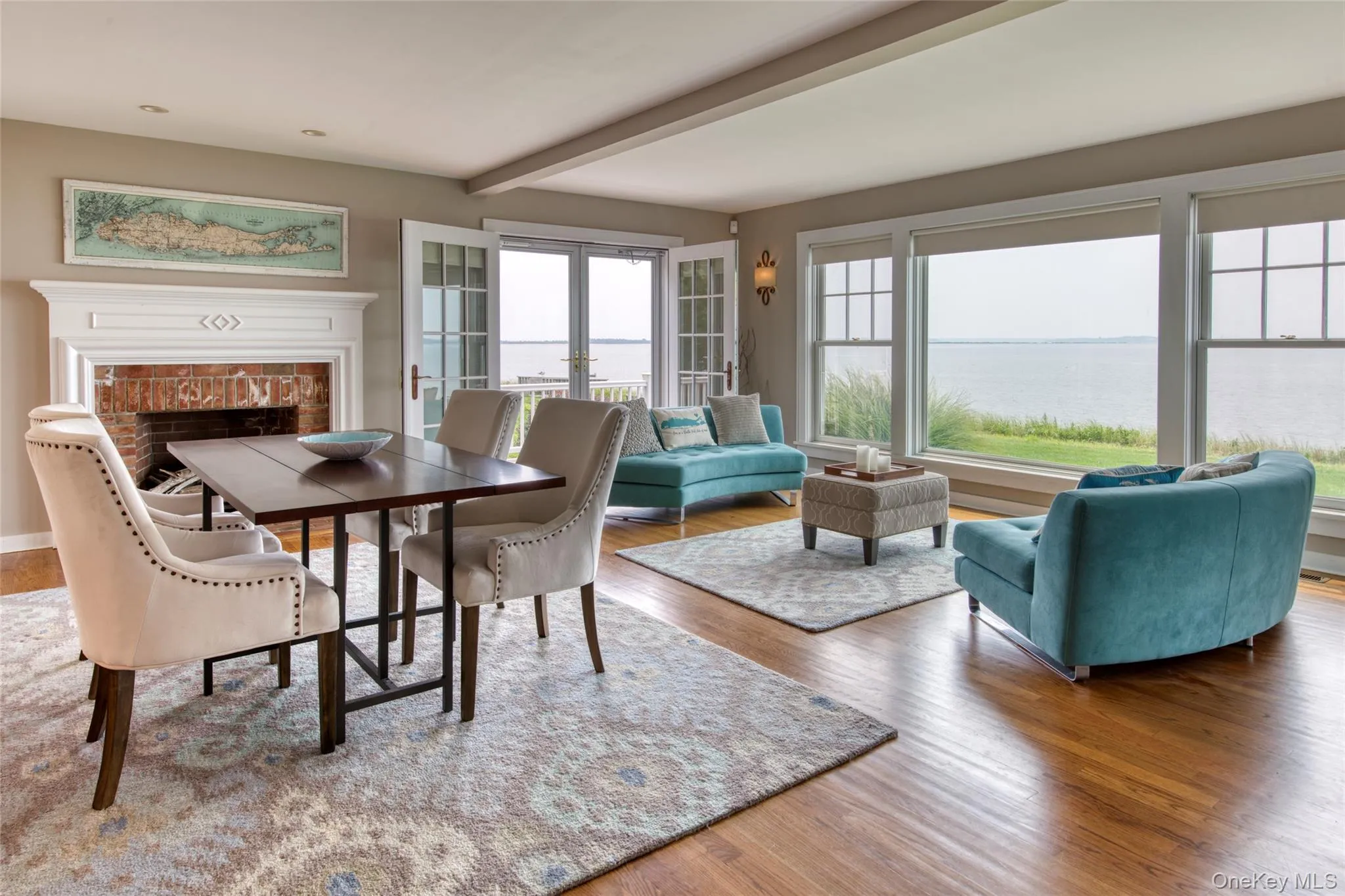 Dining space with beamed ceiling, a water view, wood-type flooring, and french doors Dining space with beamed ceiling, a water view, wood-type flooring, and french doors