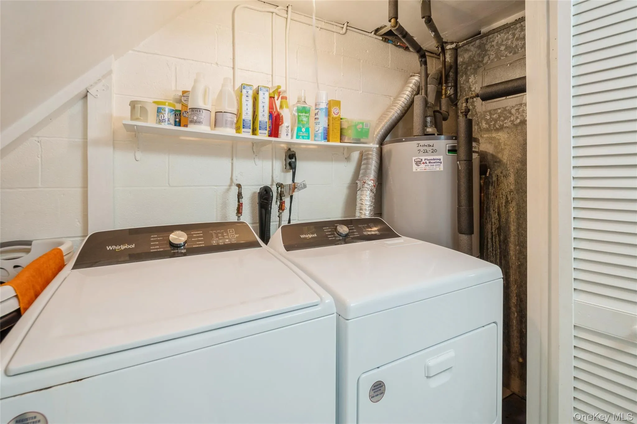 Clothes washing area featuring washer and clothes dryer and gas water heater Clothes washing area featuring washer and clothes dryer and gas water heater