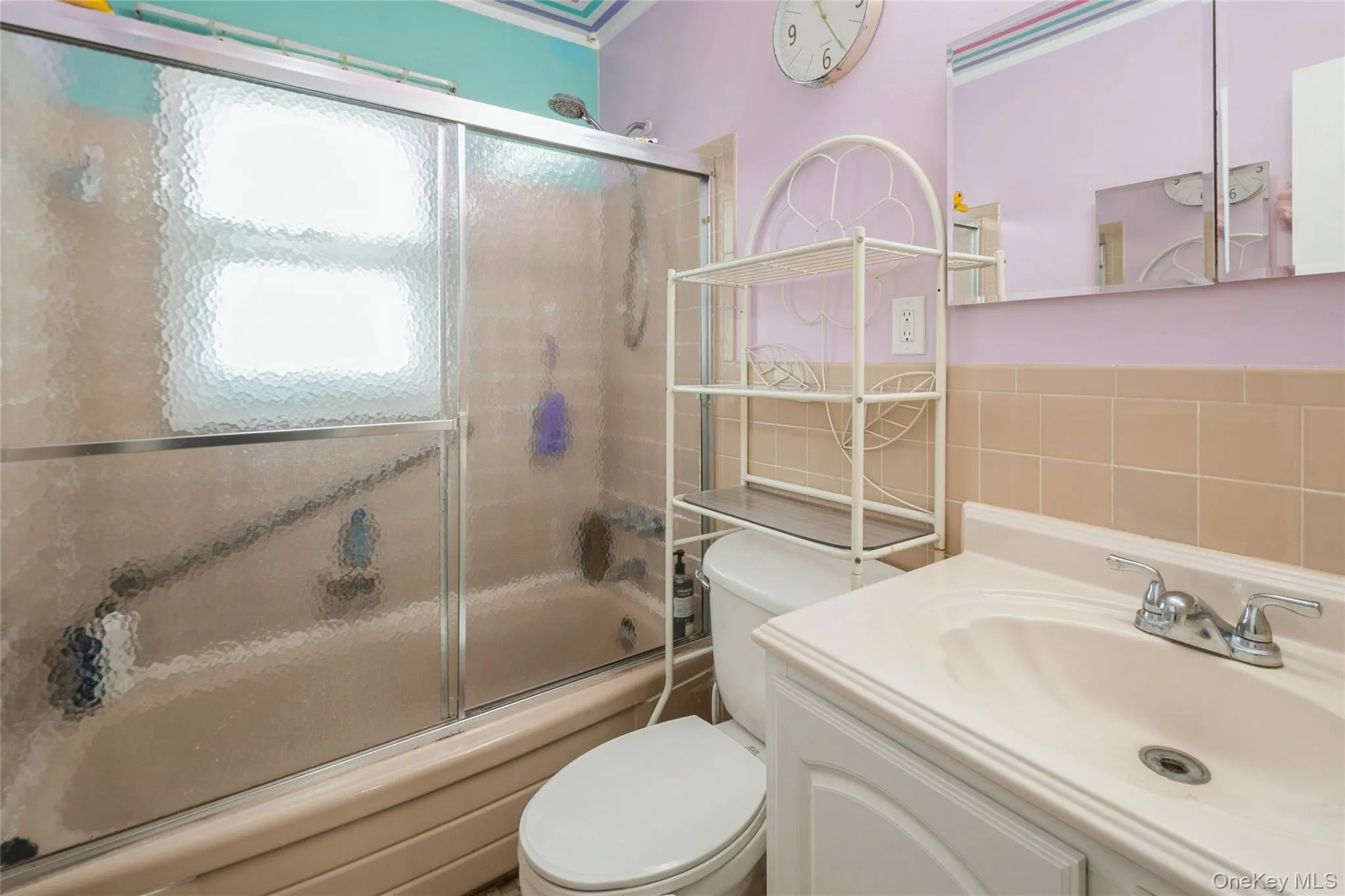 Full bathroom with toilet, enclosed tub / shower combo, and vanity Full bathroom with toilet, enclosed tub / shower combo, and vanity