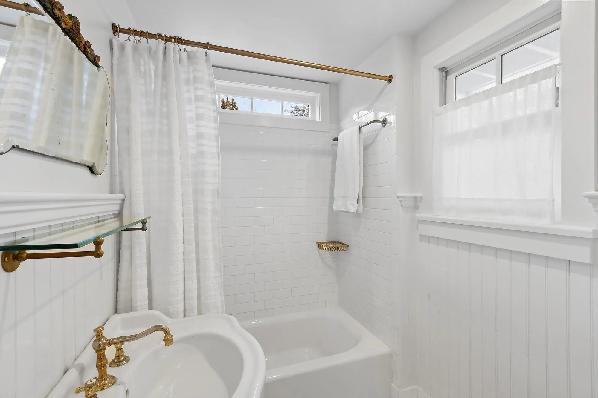 Bathroom featuring sink and shower / tub combo with curtain Bathroom featuring sink and shower / tub combo with curtain