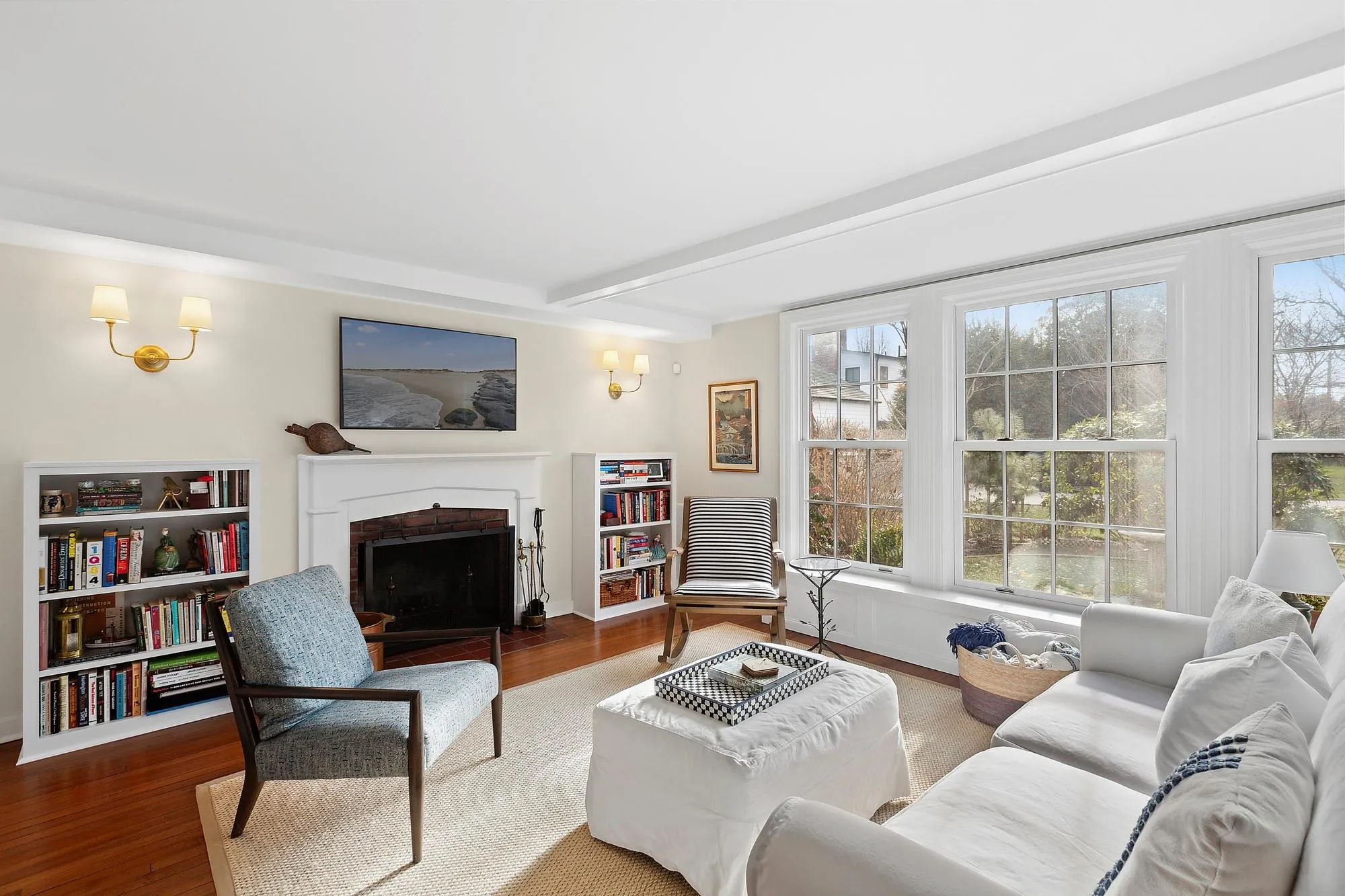 Living room featuring beam ceiling and hardwood / wood-style flooring Living room featuring beam ceiling and hardwood / wood-style flooring
