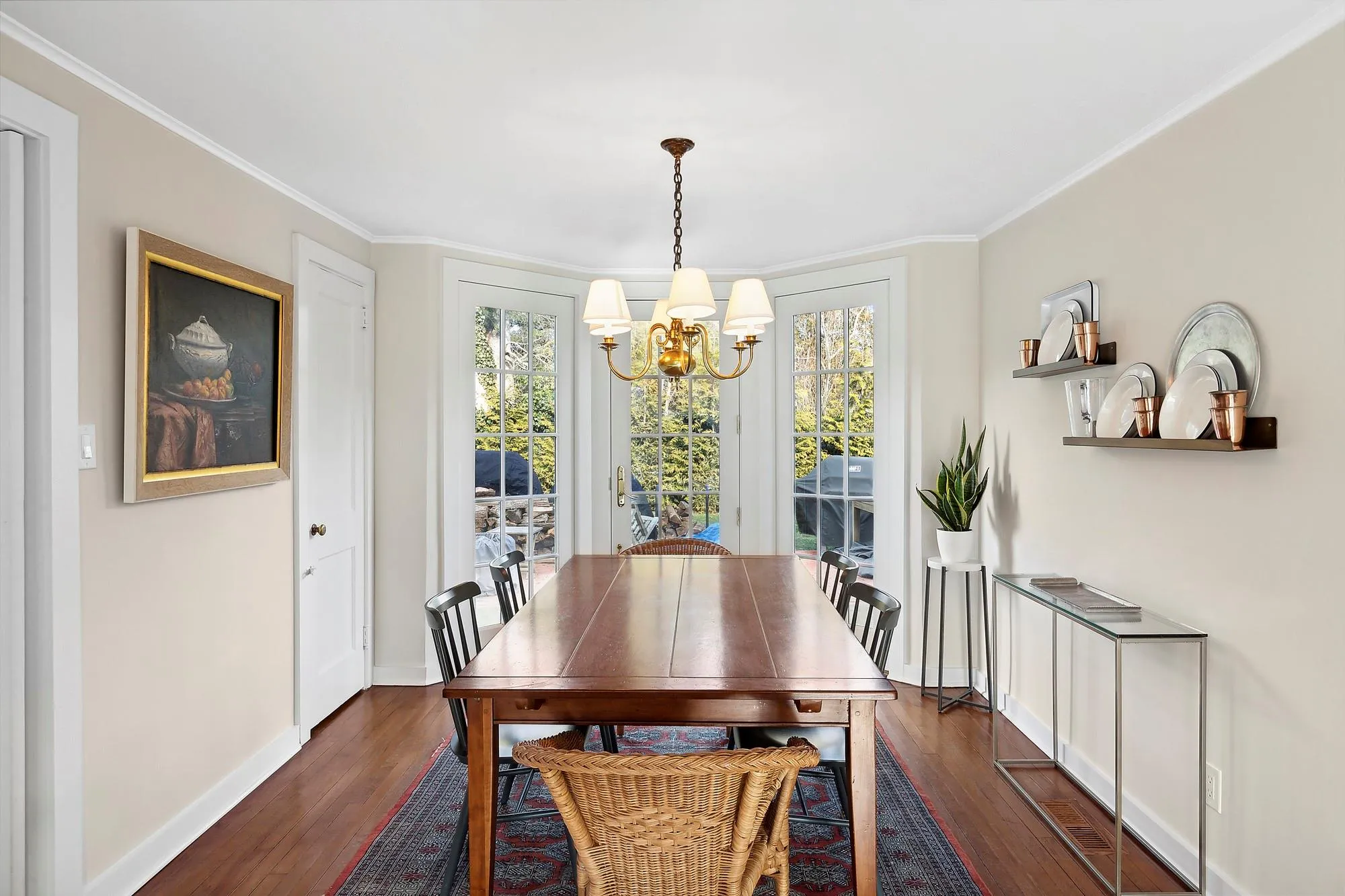 Dining space with a notable chandelier, dark hardwood / wood-style floors, and crown molding Dining space with a notable chandelier, dark hardwood / wood-style floors, and crown molding
