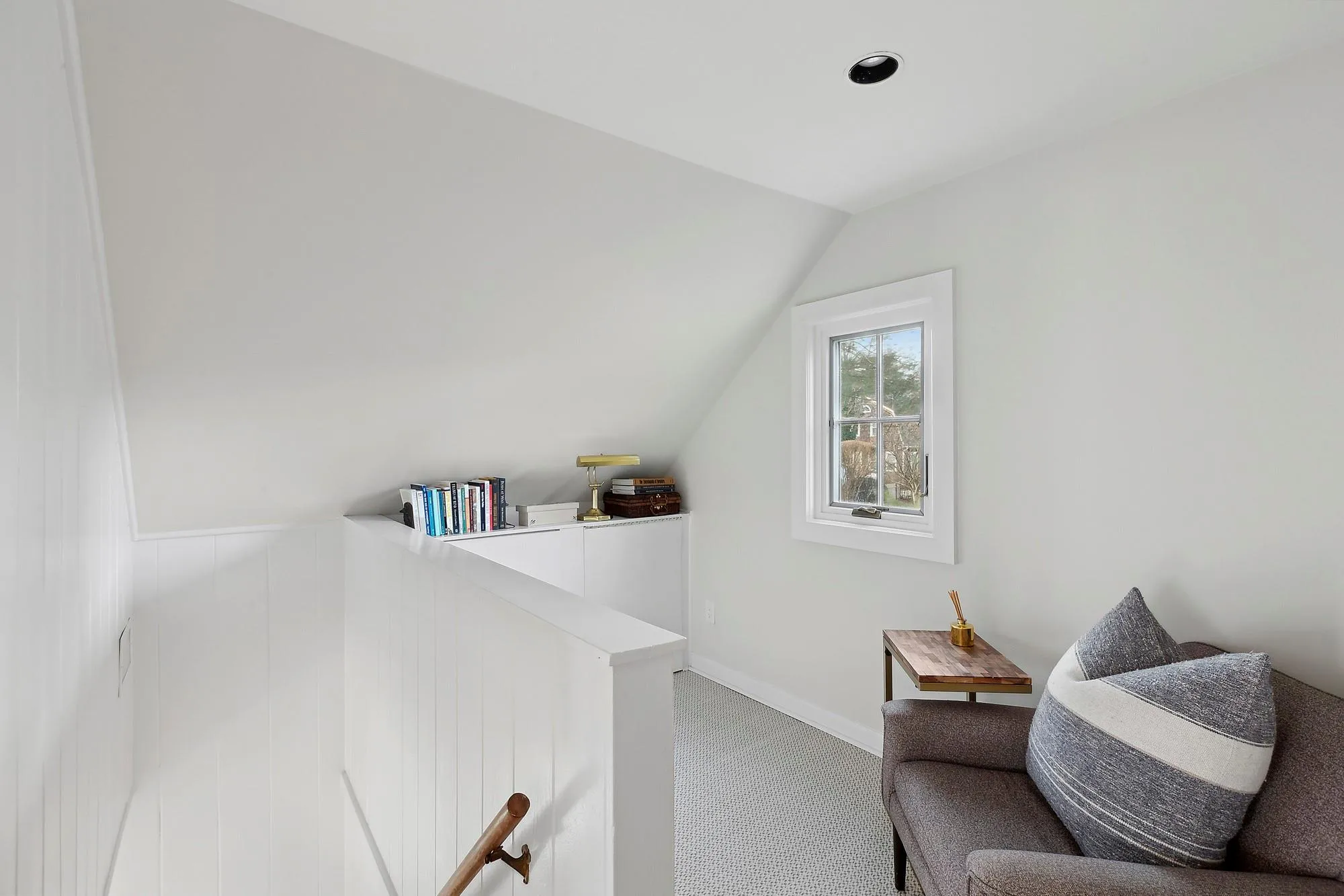 Living area with carpet floors and vaulted ceiling Living area with carpet floors and vaulted ceiling