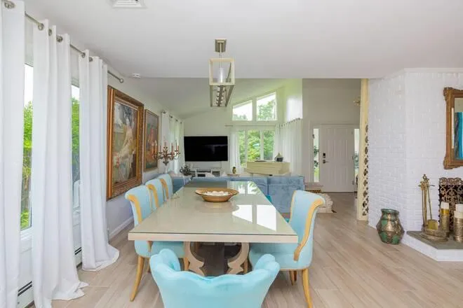 Dining room featuring light wood-type flooring and baseboard heating Dining room featuring light wood-type flooring and baseboard heating