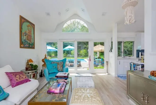 Living room with a chandelier, lofted ceiling, light hardwood / wood-style flooring, and sink Living room with a chandelier, lofted ceiling, light hardwood / wood-style flooring, and sink