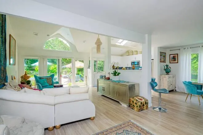 Living room with vaulted ceiling and light wood-type flooring Living room with vaulted ceiling and light wood-type flooring
