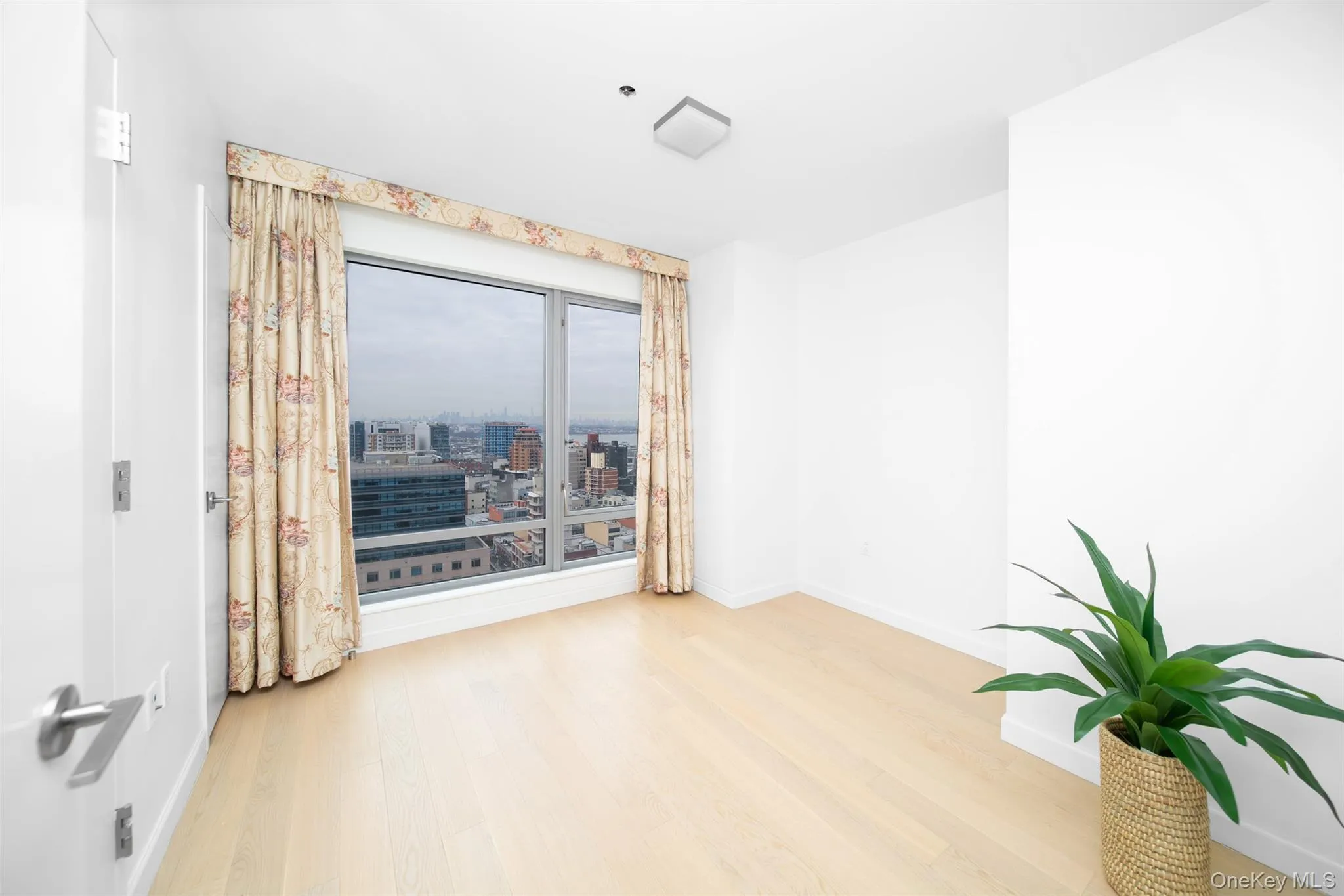 Spare room featuring hardwood / wood-style flooring Spare room featuring hardwood / wood-style flooring