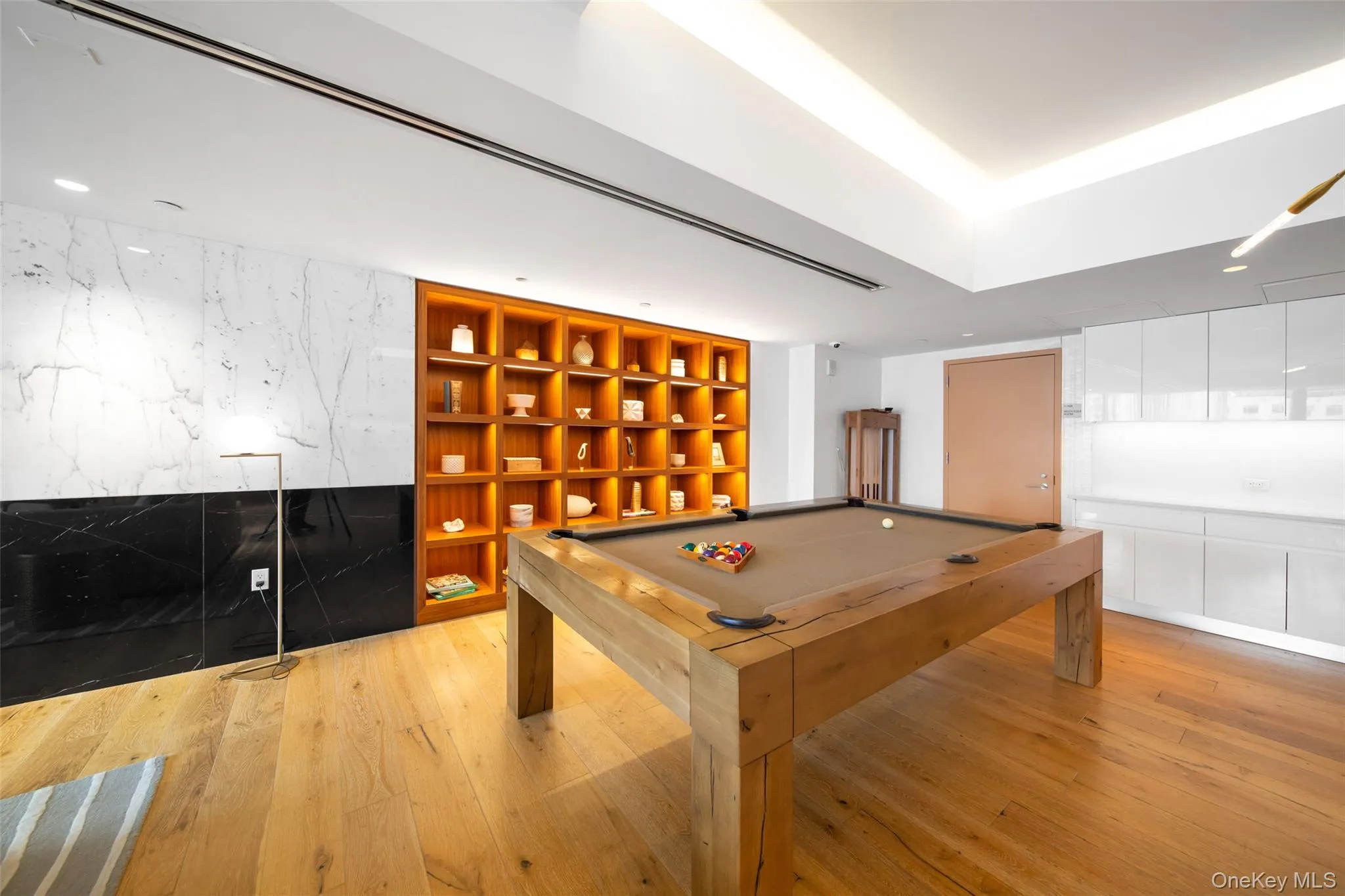 Game room featuring billiards, light wood-type flooring, and built in features Game room featuring billiards, light wood-type flooring, and built in features