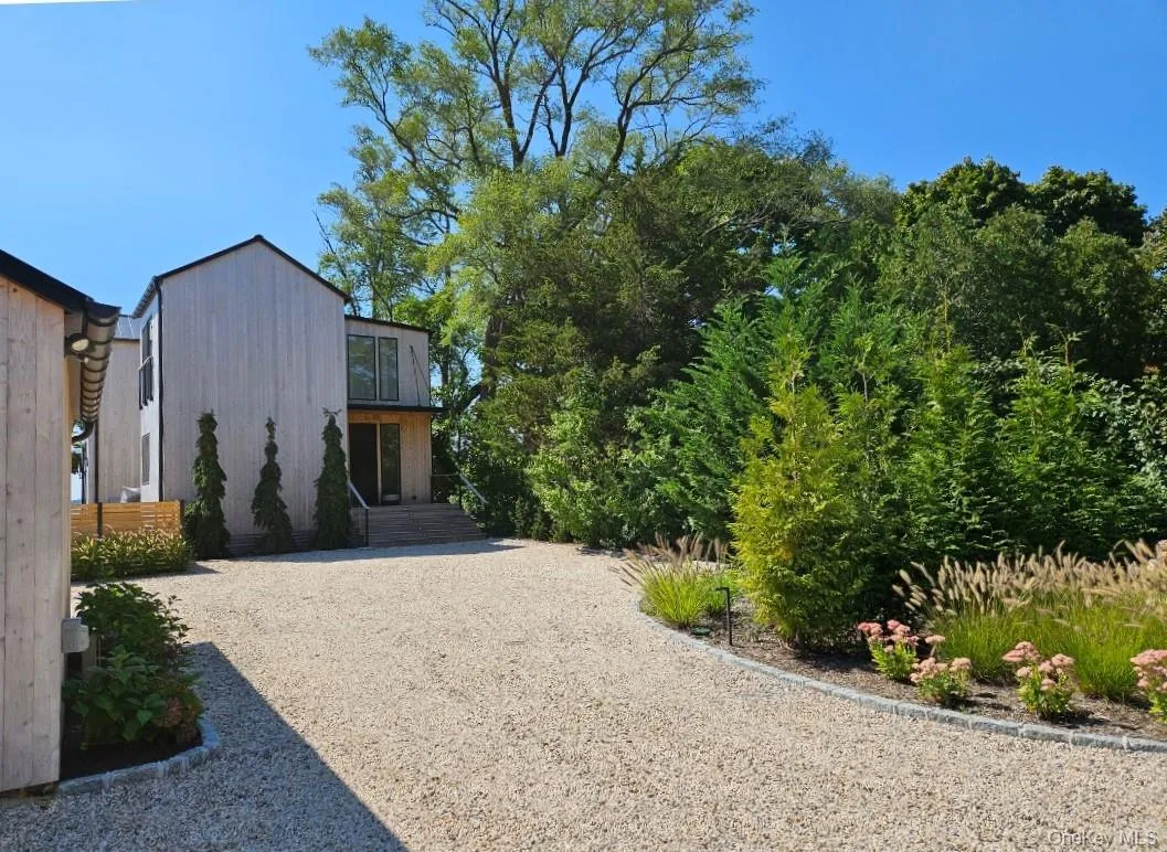 View of yard featuring gravel driveway View of yard featuring gravel driveway
