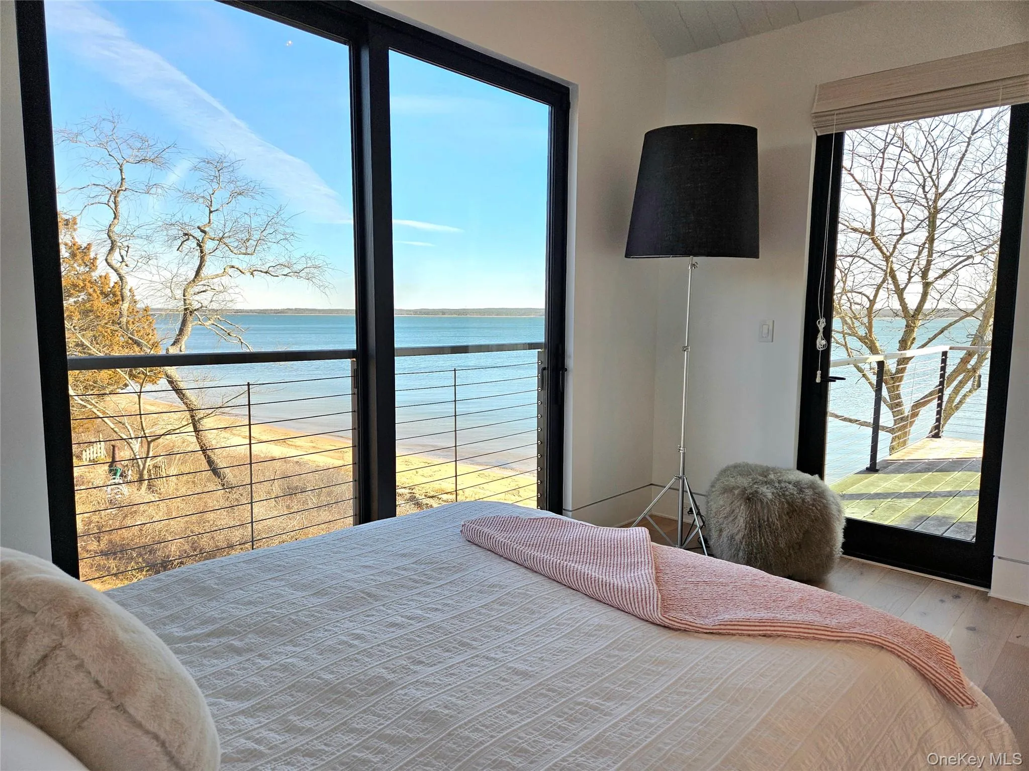 Bedroom with a water view and wood finished floors Bedroom with a water view and wood finished floors