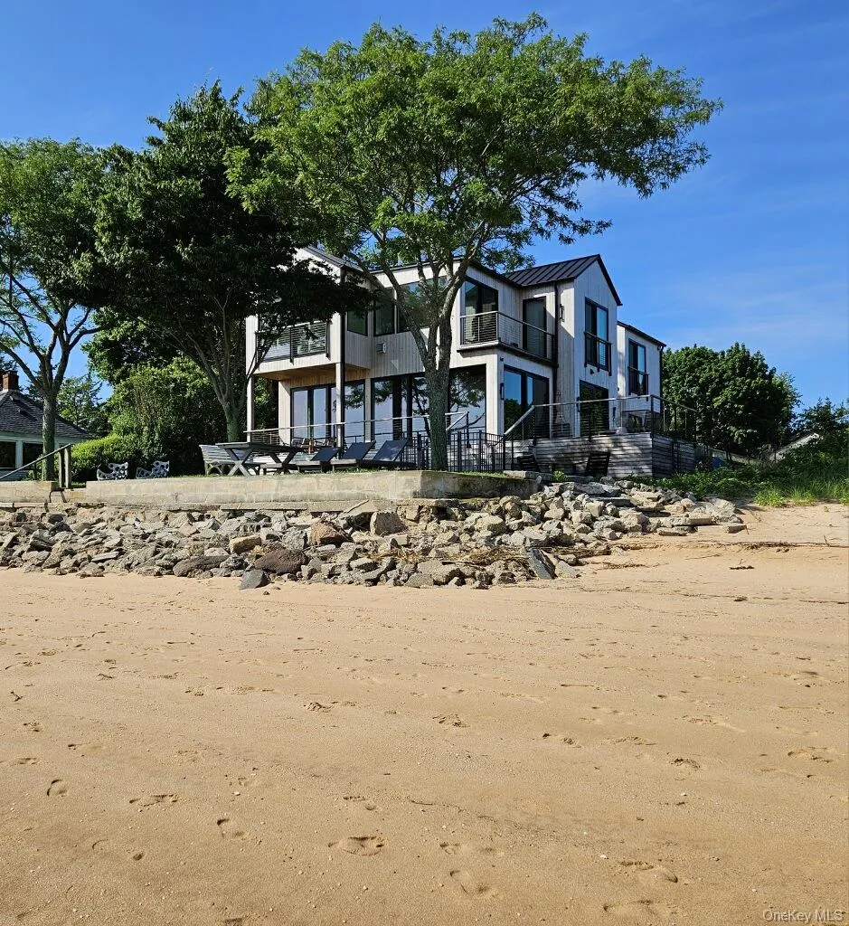 View of front of property featuring a balcony, a standing seam roof, and metal roof View of front of property featuring a balcony, a standing seam roof, and metal roof