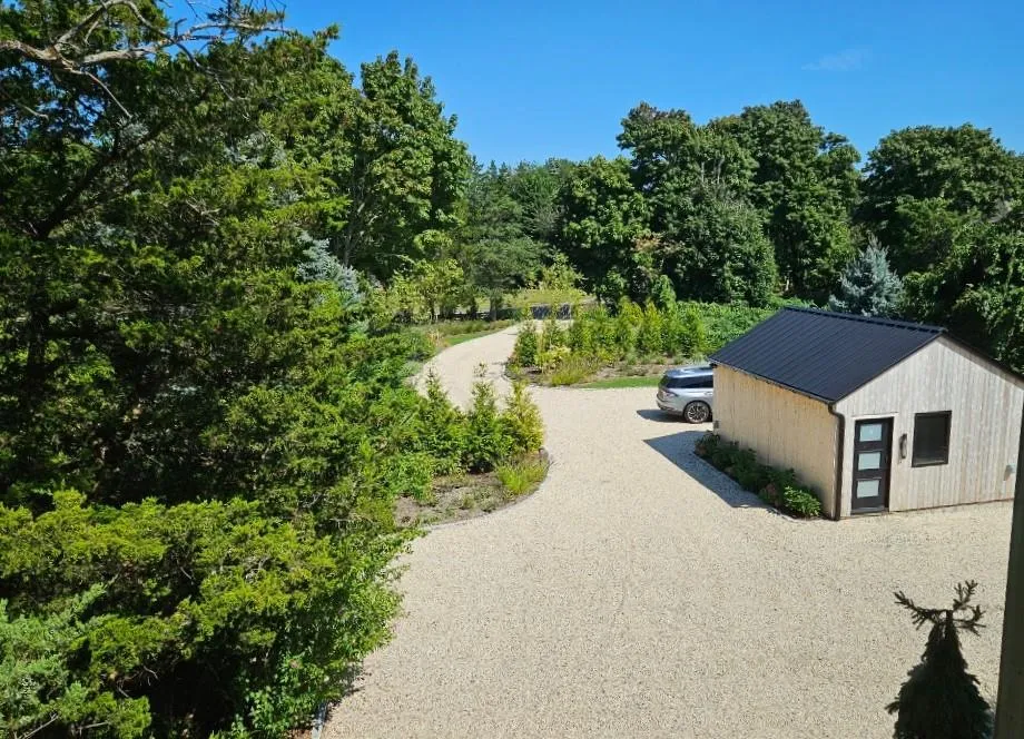 Surrounding community featuring an outbuilding, gravel driveway, and a wooded view Surrounding community featuring an outbuilding, gravel driveway, and a wooded view