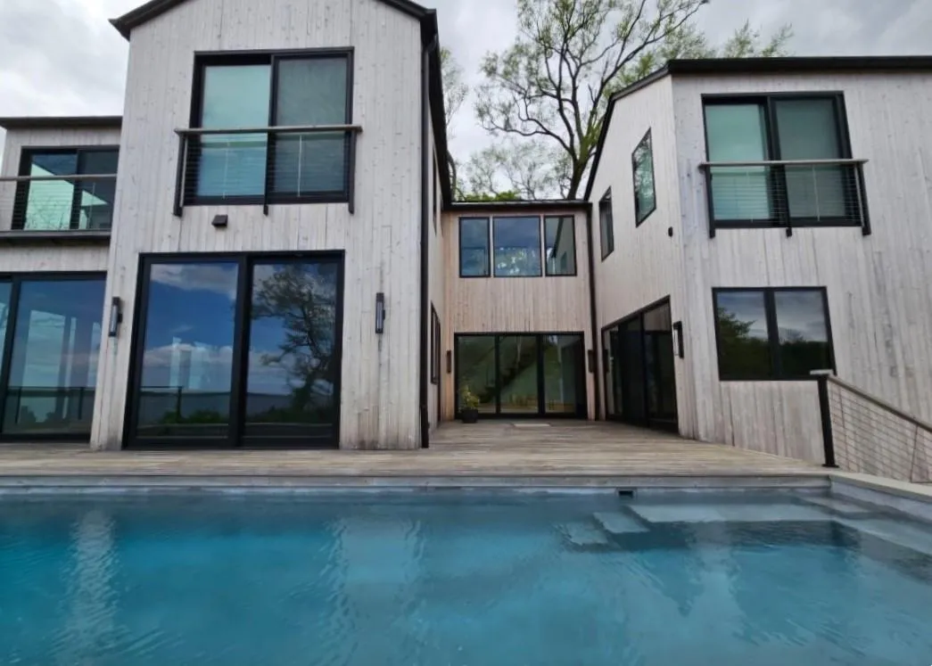 Back of property featuring an outdoor pool and a deck Back of property featuring an outdoor pool and a deck