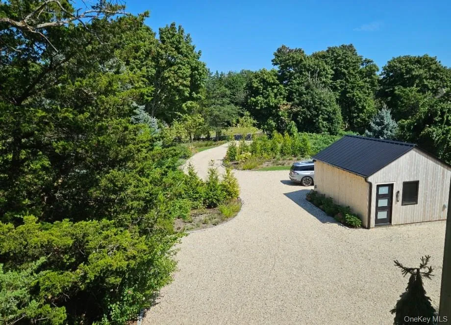 Surrounding community featuring an outbuilding, gravel driveway, and a wooded view Surrounding community featuring an outbuilding, gravel driveway, and a wooded view