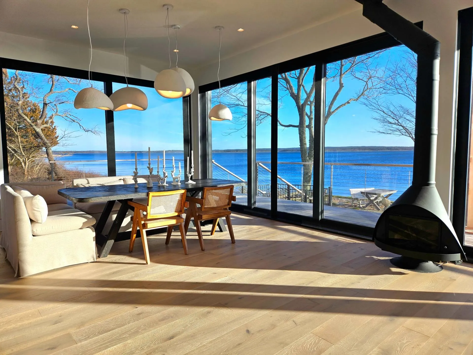 Sunroom featuring a wood stove and a water view Sunroom featuring a wood stove and a water view