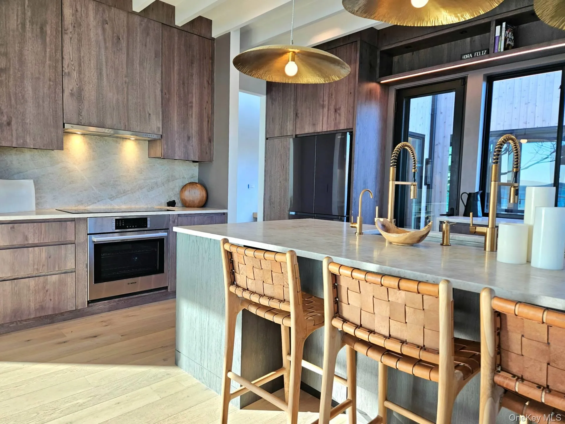 Kitchen with extractor fan, light countertops, stainless steel oven, and modern cabinets Kitchen with extractor fan, light countertops, stainless steel oven, and modern cabinets