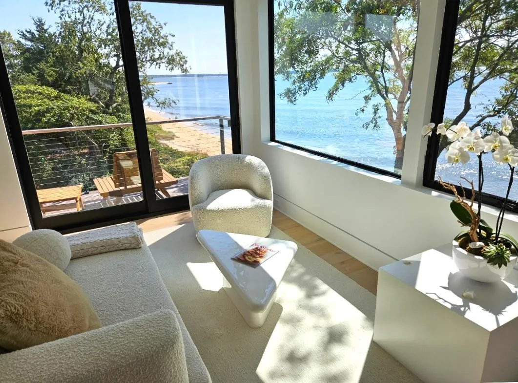 Sitting room with wood finished floors and a water view Sitting room with wood finished floors and a water view