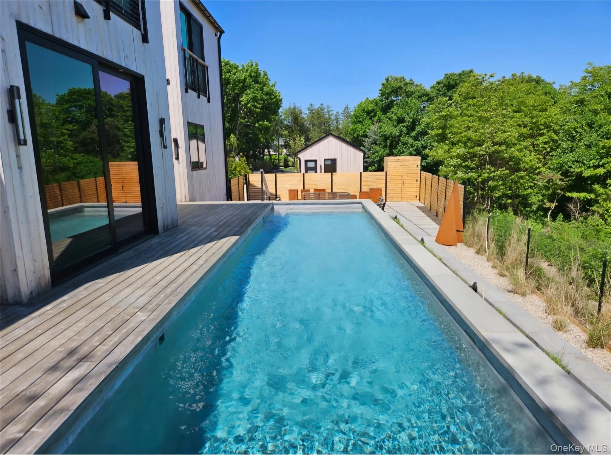 View of swimming pool featuring a fenced in pool, a deck, and a fenced backyard View of swimming pool featuring a fenced in pool, a deck, and a fenced backyard