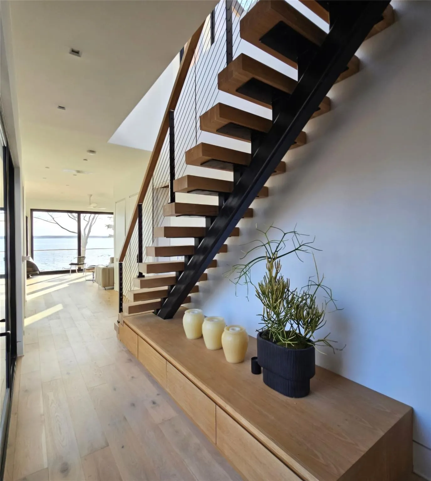 Stairs with wood-type flooring and a water view Stairs with wood-type flooring and a water view