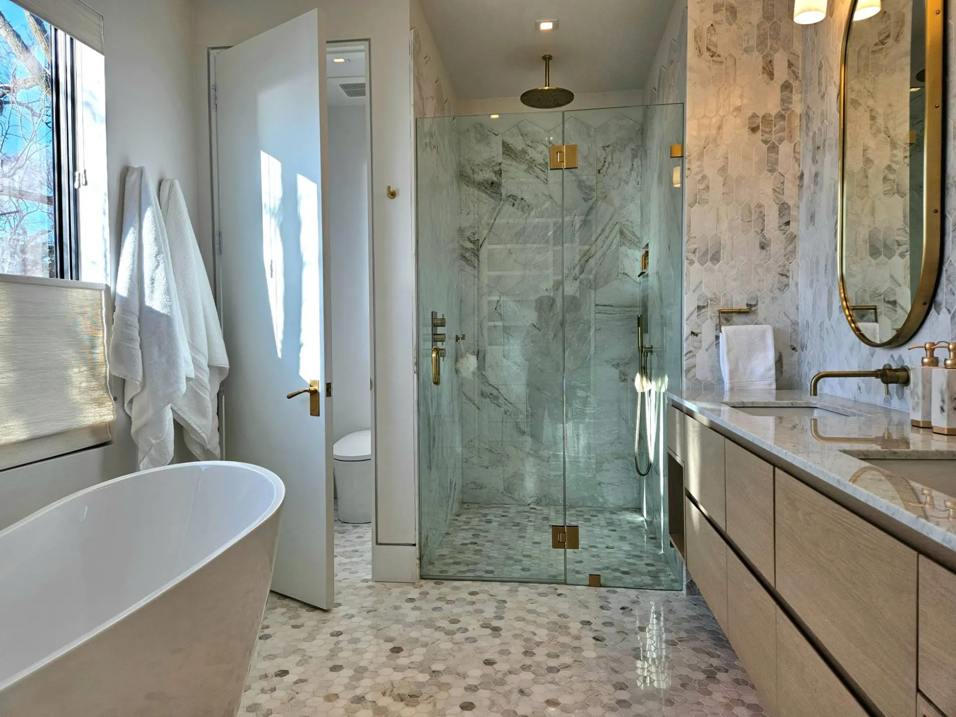 Bathroom with a shower stall, a freestanding tub, vanity, and toilet Bathroom with a shower stall, a freestanding tub, vanity, and toilet