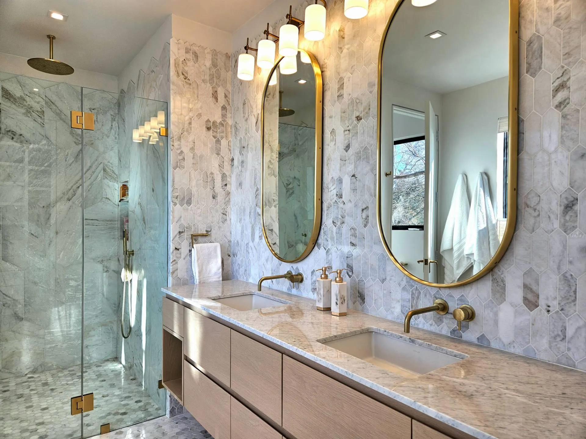 Full bath featuring double vanity, a marble finish shower, and a sink Full bath featuring double vanity, a marble finish shower, and a sink
