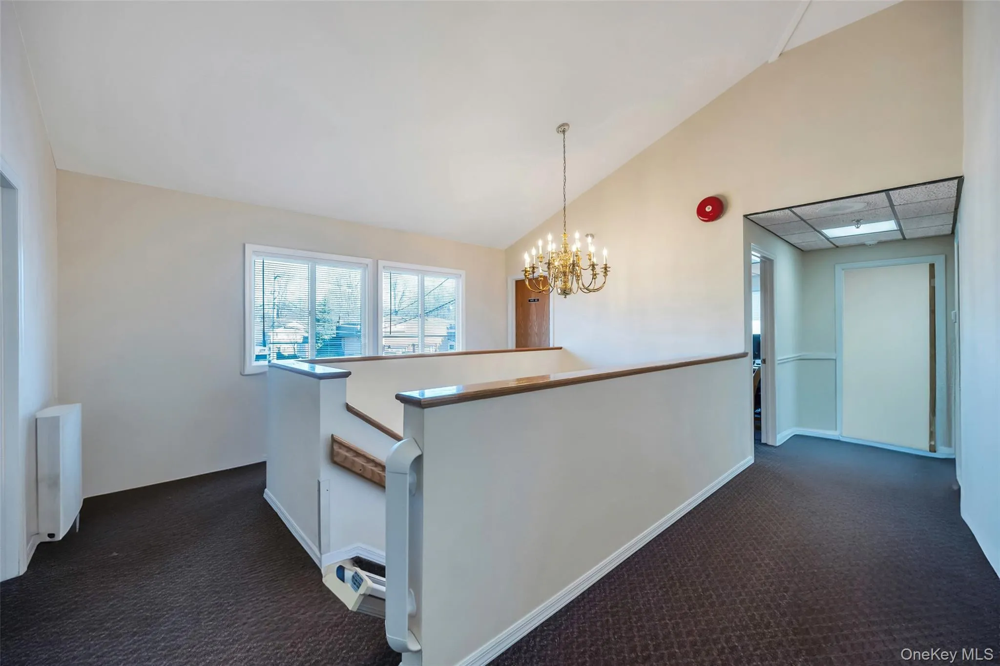 Kitchen featuring radiator, dark carpet, an inviting chandelier, and pendant lighting Kitchen featuring radiator, dark carpet, an inviting chandelier, and pendant lighting